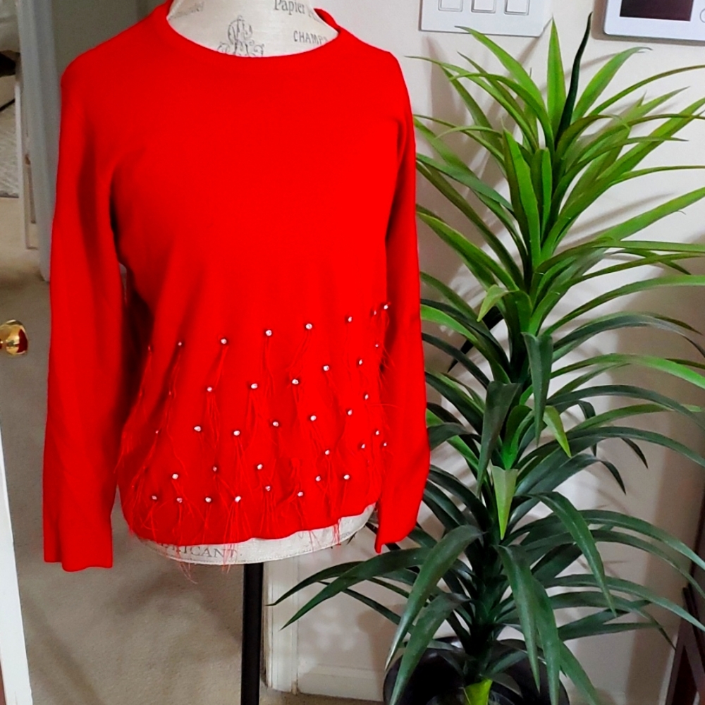 Red M sweater long sleeve and round neck. It has silver stones half way down.$12